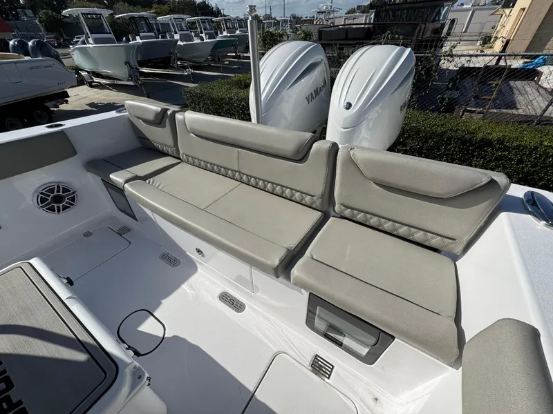 Slide: The Image of 2025 Sportsman Heritage 261 boat with beige seating and dual Yamaha engines. - 25