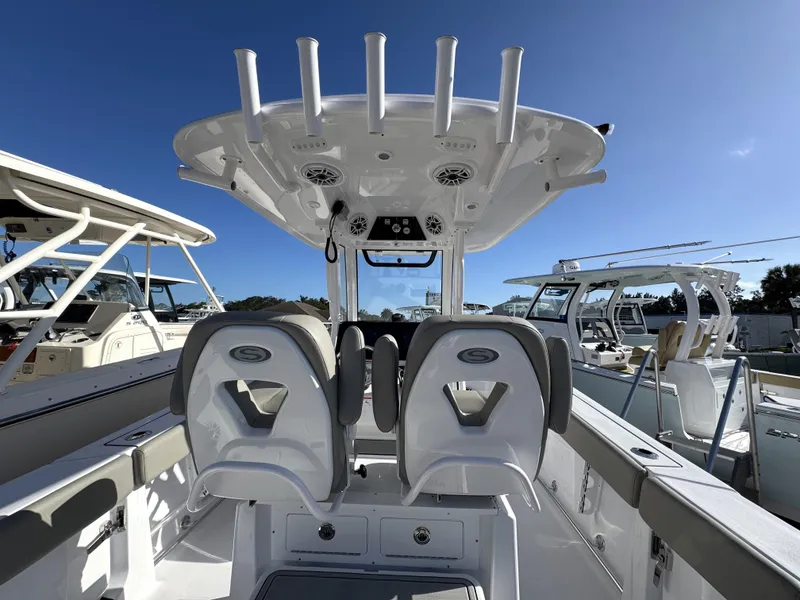 Slide: The Image of 2025 Sportsman Heritage 261 boat interior with dual seats and overhead rod holders. - 27