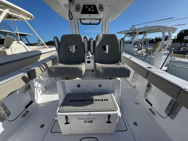 Slide: The Image of 2025 Sportsman Heritage 261 boat interior with dual seats and Yeti cooler. - 30