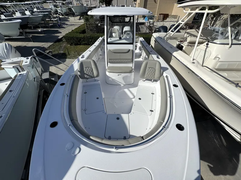 Slide: The Image of 2025 Sportsman Heritage 261 boat, spacious deck, modern design, parked among other boats. - 4