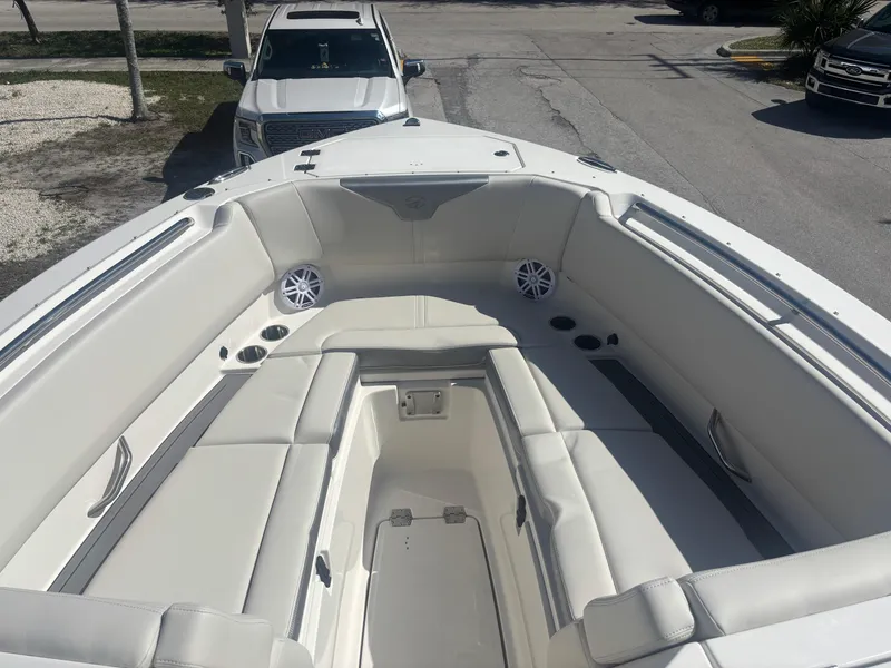 Slide: The Image of 2025 Sailfish 276 DC boat interior with white seating and cup holders. - 10