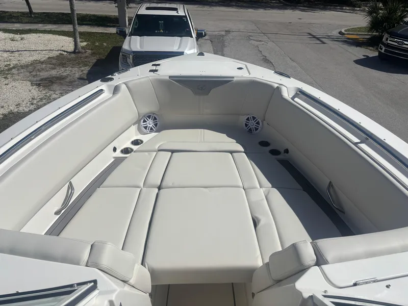 Slide: The Image of 2025 Sailfish 276 DC boat interior with white seating and speakers. - 11