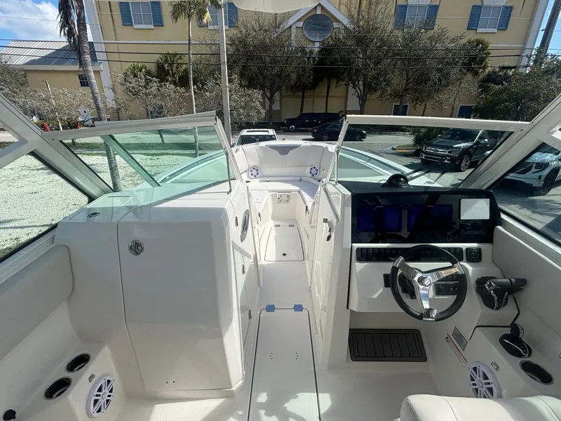 Slide: The Image of 2025 Sailfish 276 DC boat interior with modern dashboard and steering wheel. - 12