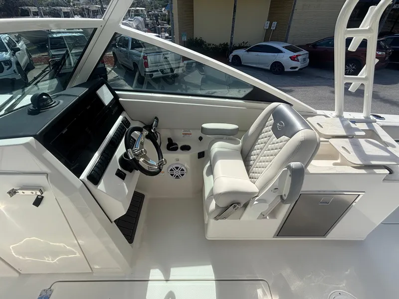 Slide: The Image of 2025 Sailfish 276 DC boat cockpit with modern steering and plush seating. - 13