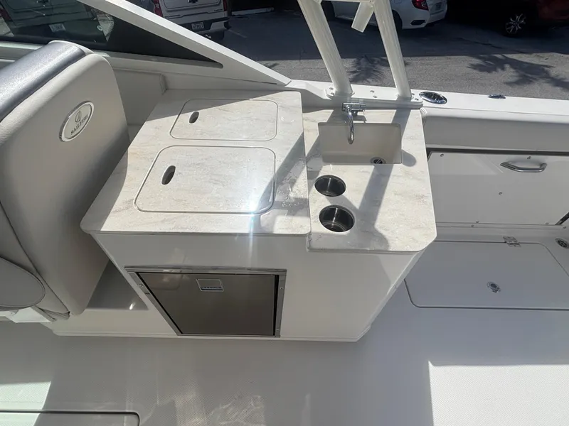 Slide: The Image of 2025 Sailfish 276 DC boat interior with sink and storage area. - 17