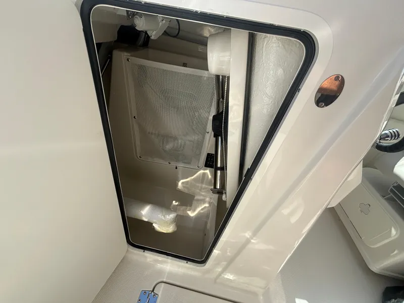 Slide: The Image of 2025 Sailfish 276 DC boat interior compartment with open hatch and visible storage area. - 20