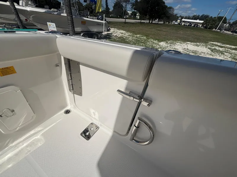 Slide: The Image of 2025 Sailfish 276 DC boat interior with white seating and stainless steel fixtures. - 25