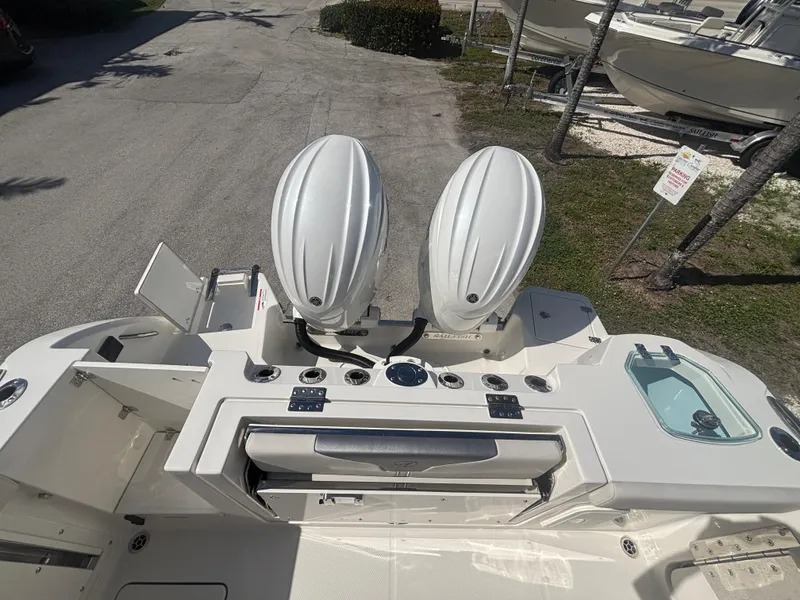 Slide: The Image of 2025 Sailfish 276 DC boat with dual outboard motors, viewed from above. - 26
