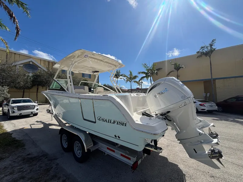 Slide: The Image of 2025 Sailfish 276 DC boat on trailer under sunny sky. - 3