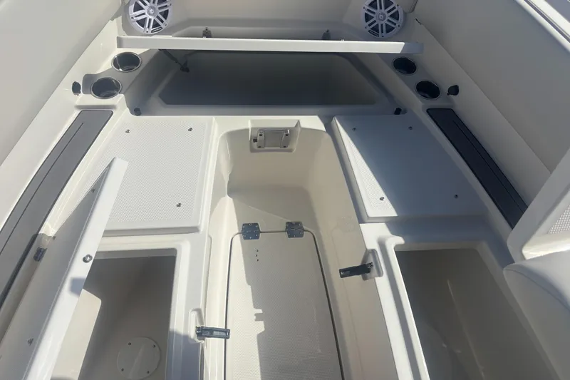 Slide: The Image of 2025 Sailfish 276 DC boat interior with storage compartments and cup holders. - 9