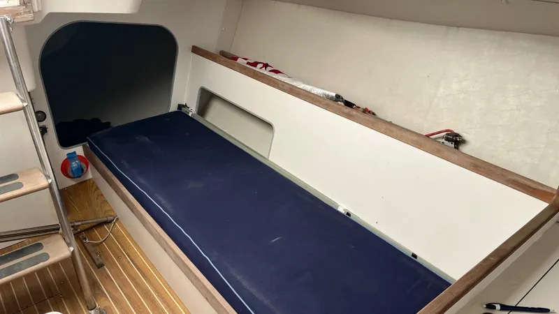 Slide: The Image of Interior of 2000 J Boats J/105 sailboat with blue cushioned bench. - 14