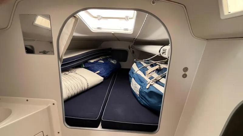 Slide: The Image of Interior cabin of a 2000 J Boats J/105 sailboat with cushions and storage bags. - 15