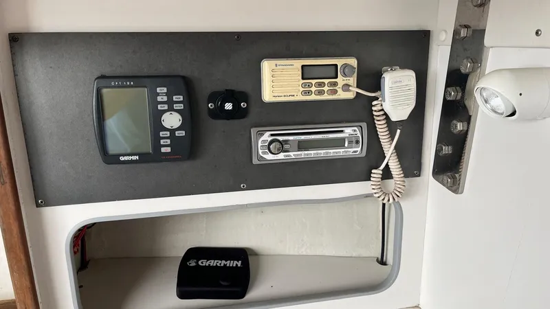 Slide: The Image of Control panel of a 2000 J Boats J/105 with Garmin and communication devices. - 16