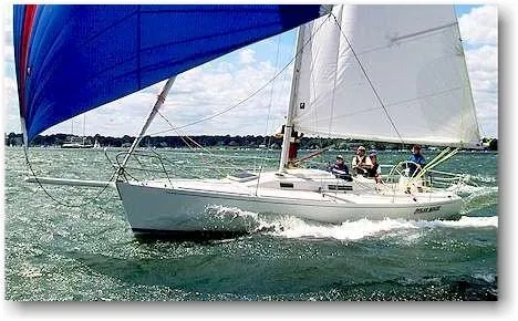 Slide: The Image of 2000 J Boats J/105 sailing on open water with vibrant sails. - 2