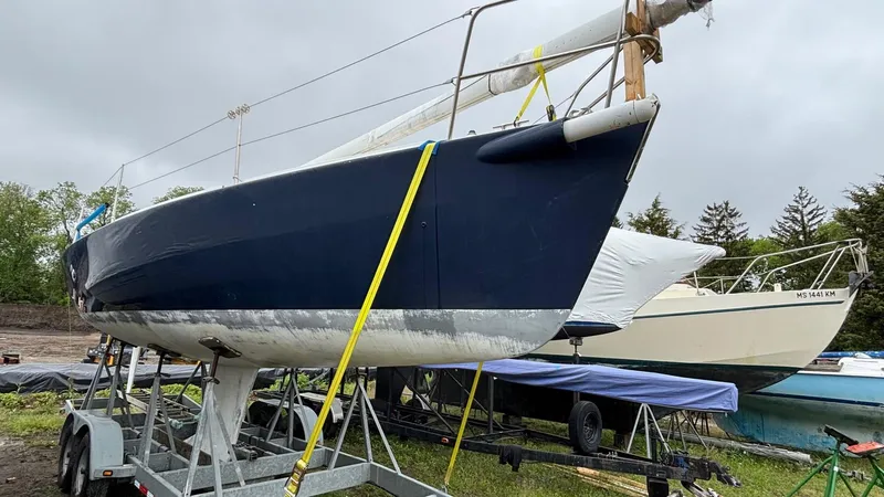 Slide: The Image of 2000 J Boats J/105 sailboat on trailer, blue hull, stored outdoors. - 27