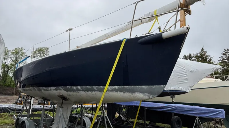 Slide: The Image of 2000 J Boats J/105 sailboat on trailer, blue hull, stored outdoors. - 29