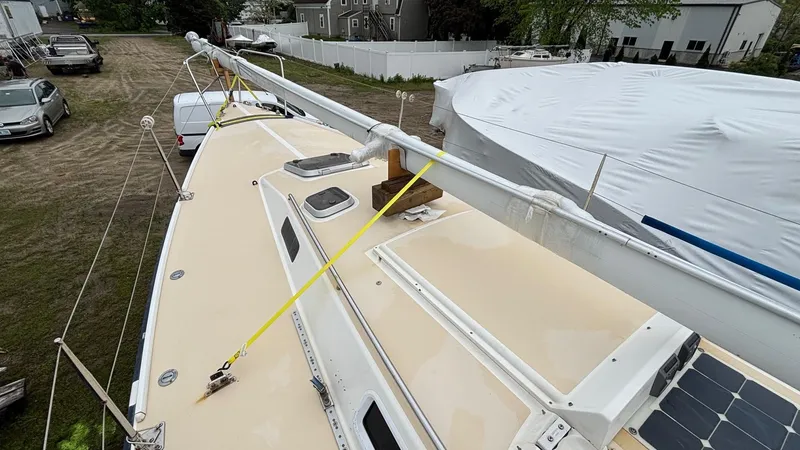 Slide: The Image of 2000 J Boats J/105 sailboat deck with mast and solar panel, parked outdoors. - 32