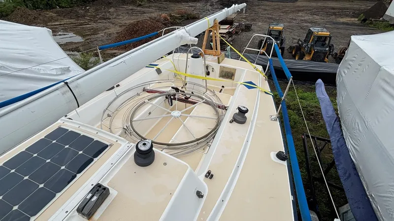 Slide: The Image of 2000 J Boats J/105 sailboat on land, deck view with solar panel and equipment. - 33