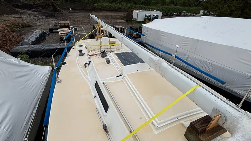 Slide: The Image of 2000 J Boats J/105 sailboat on land, mast down, in a boatyard. - 34