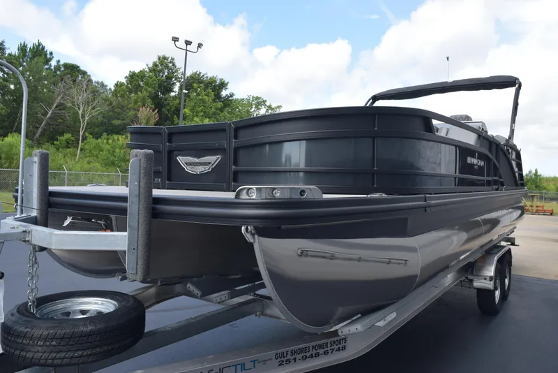 Slide: The Image of 2023 Bennington 25 RTFB pontoon boat on trailer, parked outdoors. - 4