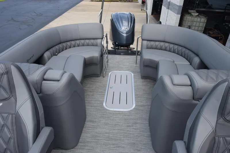 Slide: The Image of 2023 Bennington 25 RTFB pontoon boat interior with gray seating and outboard motor. - 6