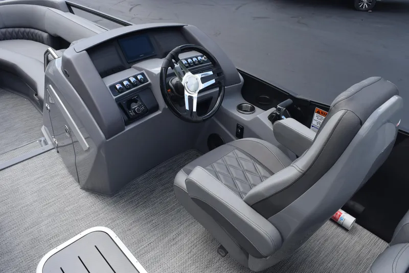 Slide: The Image of 2023 Bennington 25 RTFB boat interior with modern steering console and seating. - 7