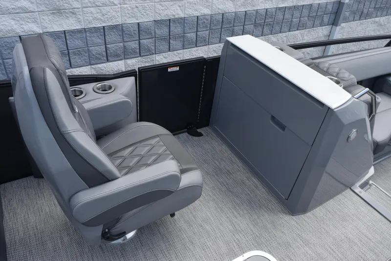 Slide: The Image of 2023 Bennington 25 RTFB boat interior with gray seating and storage console. - 8