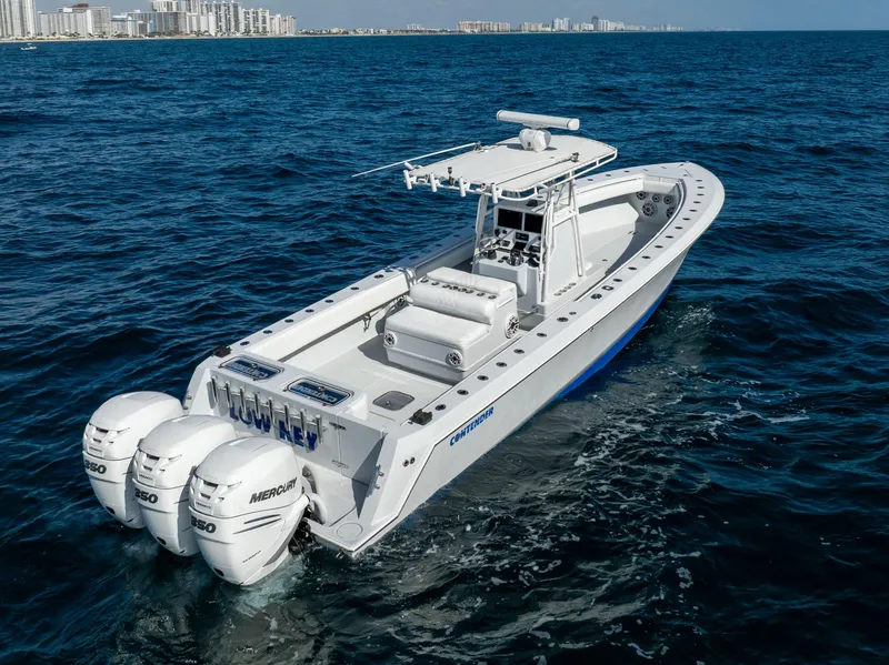 Slide: The Image of 2006 Contender 33 Tournament boat with triple Mercury engines on open sea. - 16