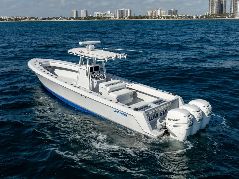 Slide: The Image of 2006 Contender 33 Tournament boat cruising on ocean with city skyline in background. - 17