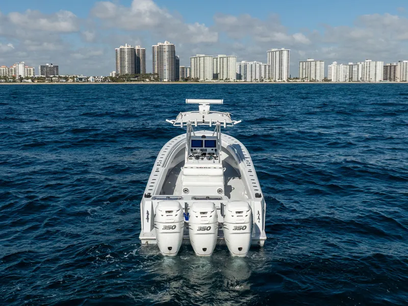 Slide: The Image of 2006 Contender 33 Tournament boat with triple engines on open water, city skyline in background. - 18