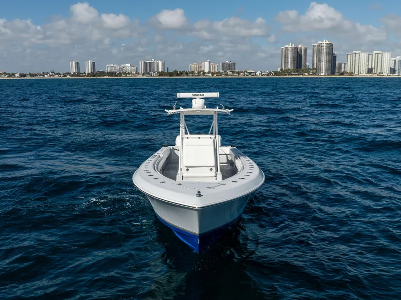 Slide: The Image of 2006 Contender 33 Tournament boat on ocean with city skyline in background. - 19