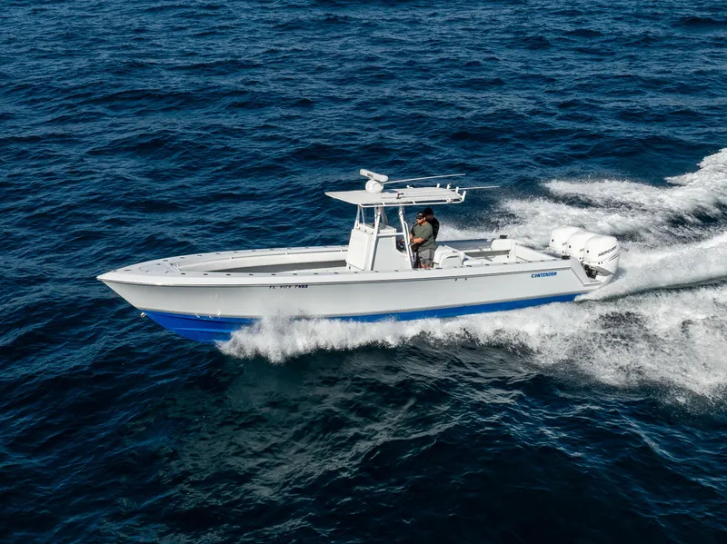 Slide: The Image of 2006 Contender 33 Tournament boat cruising on open water. - 20