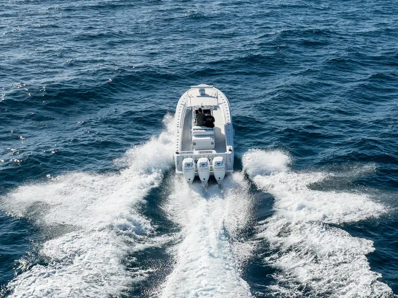 Slide: The Image of 2006 Contender 33 Tournament boat cruising on open ocean waters. - 24