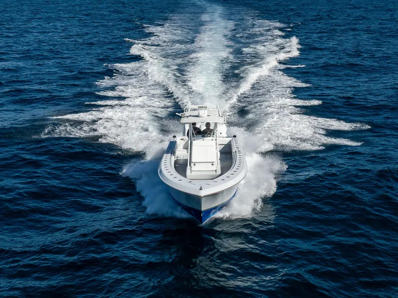 Slide: The Image of 2006 Contender 33 Tournament boat cruising on open water, creating a wake. - 25