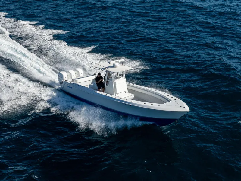 Slide: The Image of 2006 Contender 33 Tournament boat cruising on open water, showcasing speed and performance. - 26