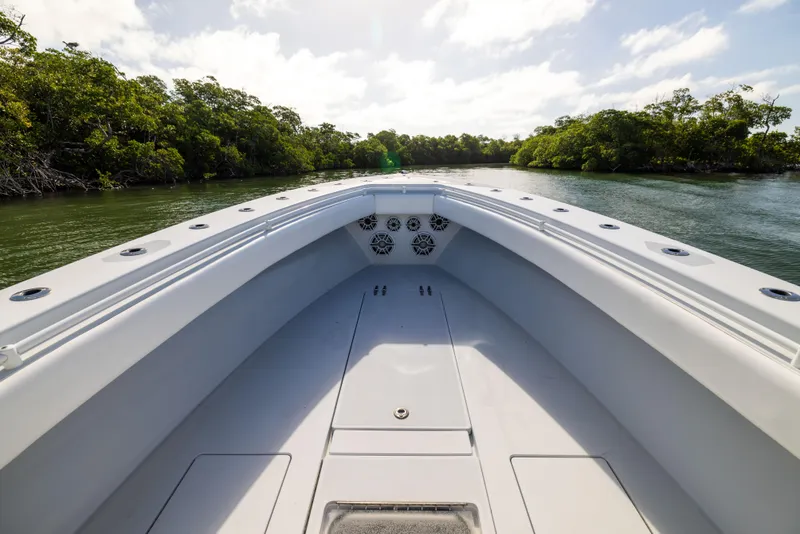 Slide: The Image of 2006 Contender 33 Tournament boat on calm water, surrounded by lush greenery. - 28