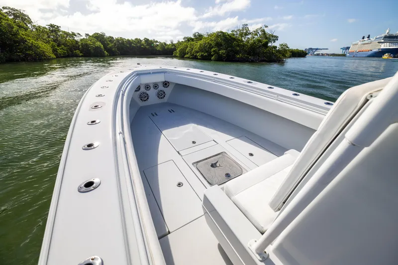 Slide: The Image of 2006 Contender 33 Tournament boat on calm water near lush greenery. - 29