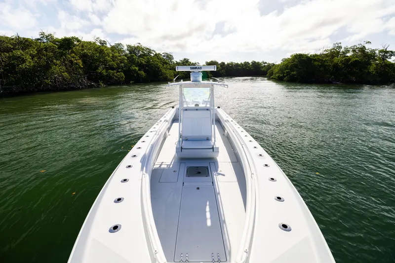 Slide: The Image of 2006 Contender 33 Tournament boat navigating through a lush, green waterway. - 31