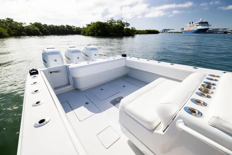 Slide: The Image of 2006 Contender 33 Tournament boat on water, featuring spacious deck and twin engines. - 35