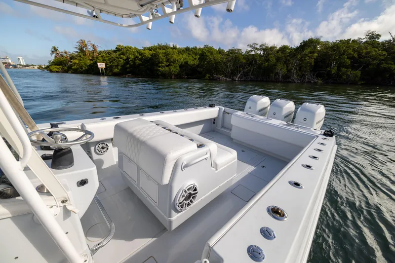 Slide: The Image of 2006 Contender 33 Tournament boat with triple engines on a calm waterway. - 38