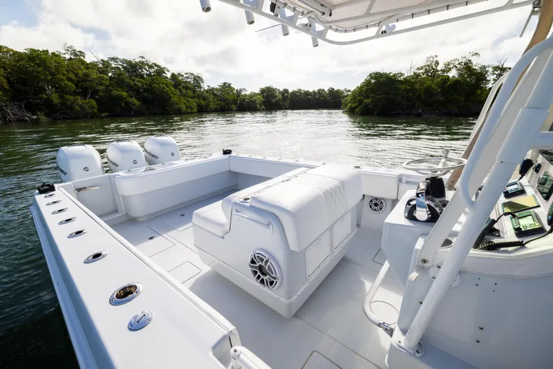 Slide: The Image of 2006 Contender 33 Tournament boat, spacious deck, triple engines, scenic water backdrop. - 40