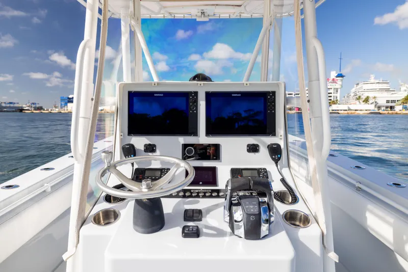 Slide: The Image of Center console of 2006 Contender 33 Tournament boat with dual screens and steering wheel. - 43