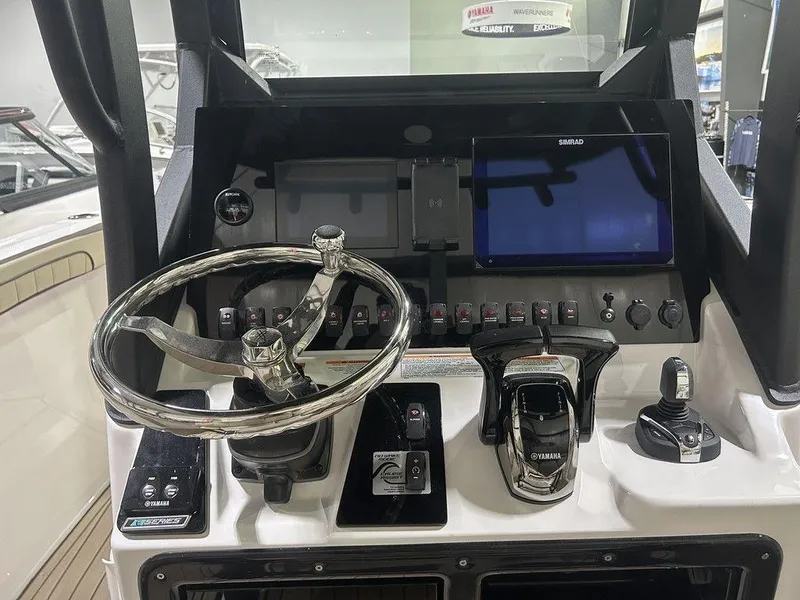 Slide: The Image of 2025 Yamaha Boats 255 FSH Sport H dashboard with steering wheel and control panel. - 4