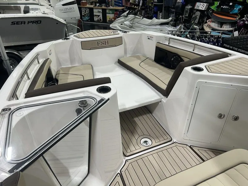 Slide: The Image of 2025 Yamaha Boats 255 FSH Sport H interior with seating and storage compartments. - 5