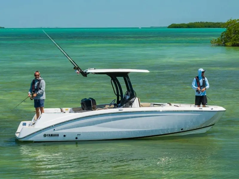 Slide: The Image of 2025 Yamaha Boats 255 FSH Sport H on clear turquoise water, two people fishing. - 6