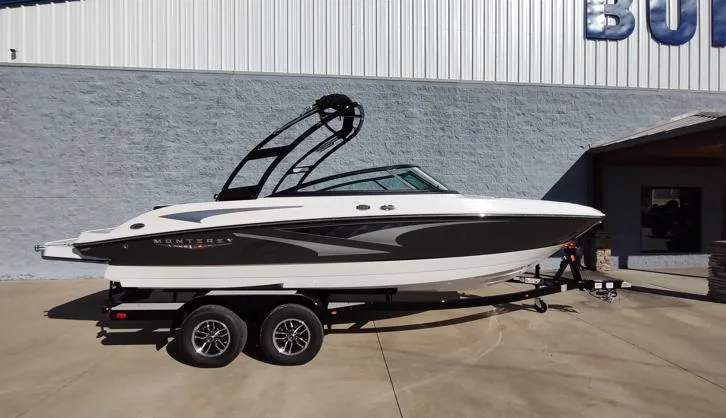 The Image of 2025 Monterey M-225 boat on trailer, parked outside a building, side view. - 1