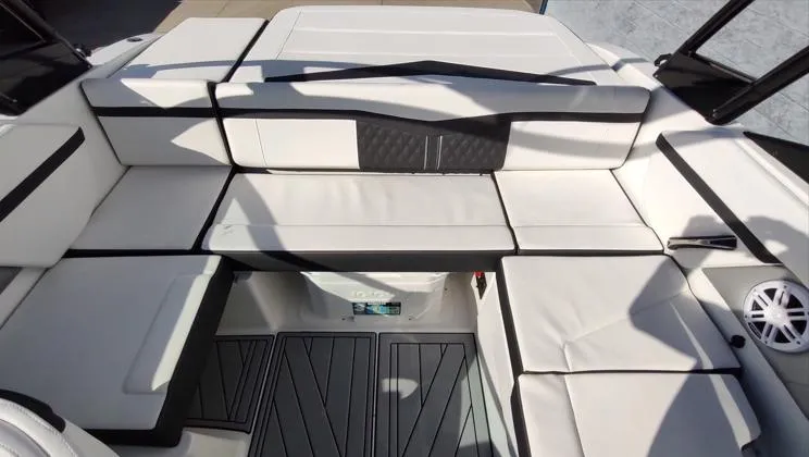 Slide: The Image of 2025 Monterey M-225 boat interior with white cushioned seating and modern design. - 10