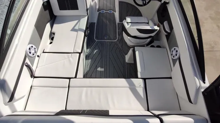 Slide: The Image of 2025 Monterey M-225 boat interior with white seating and sleek design. - 11