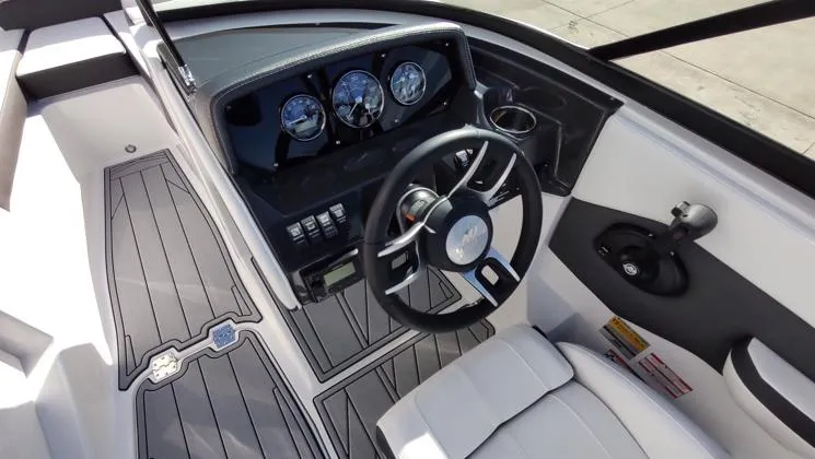 Slide: The Image of 2025 Monterey M-225 boat interior with sleek dashboard and modern steering wheel design. - 8
