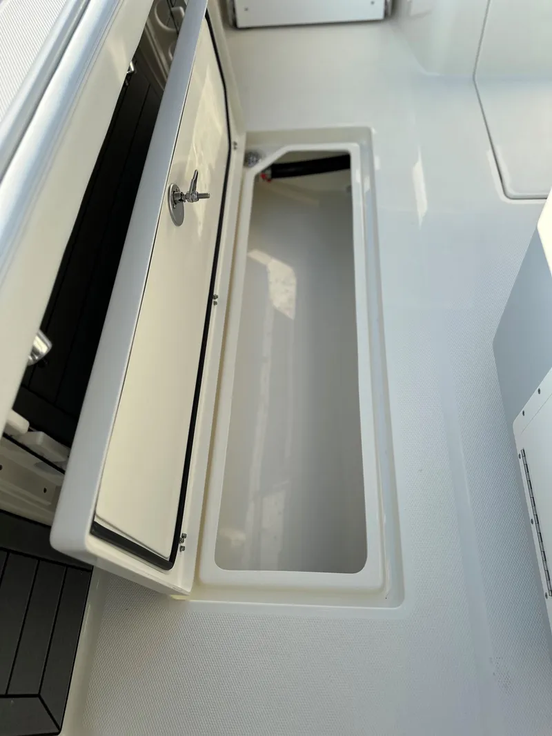 Slide: The Image of 2025 Pathfinder 2400 Open boat storage compartment with open hatch. - 14